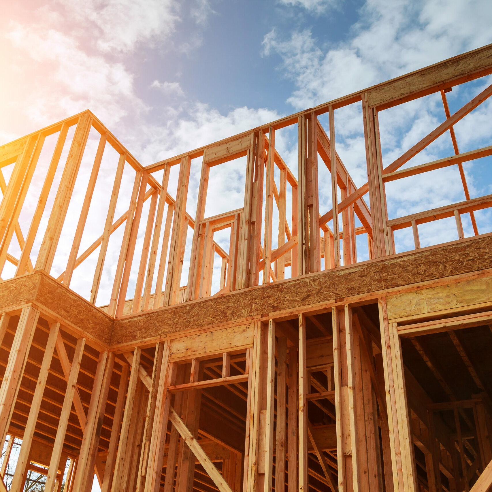 New residential construction home framing against a blue sky. Roofing construction. Wooden construction